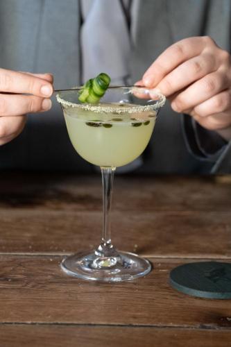 a person holding a martini glass with a pickle in it at Grays Court Hotel in York