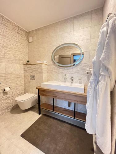 a bathroom with a sink and a toilet and a mirror at Blueberryhouse in Bukovel
