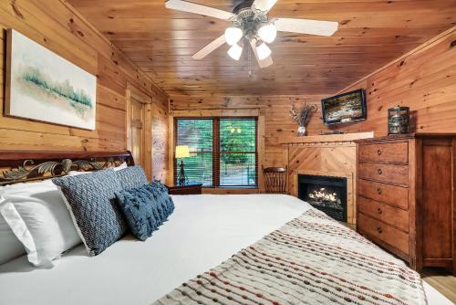 1 dormitorio con 1 cama grande y chimenea en Stay and Play at The Ryland: Private Game Room & Community Pool Retreat en Gatlinburg