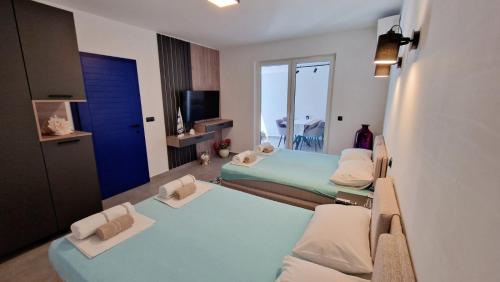 a hospital room with two beds and a window at Villa Dardona Drvenik in Drvenik