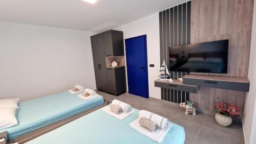 a bedroom with a bed and a flat screen tv at Villa Dardona Drvenik in Drvenik