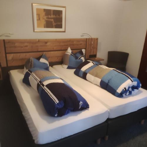 a bed with two pillows on top of it at Gasthof Goldene Krone in Selbitz