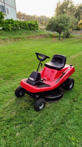 a red four wheeler sitting in the grass at Residenza Bertolini in Fosdinovo