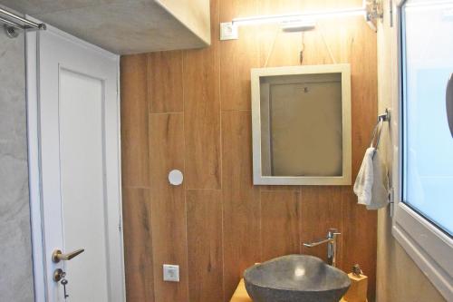 a bathroom with a sink and a mirror at MNS Marvelous Nirvana Seascape, Philosophy in Panayía