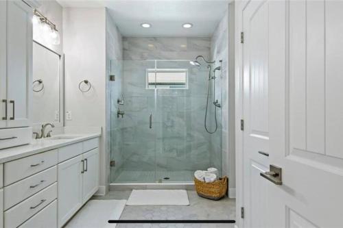 a white bathroom with a shower and a sink at Luxurious Modern Townhouse right across beach!! Table Tennis in St. Pete Beach
