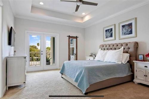 a white bedroom with a bed and a window at Luxurious Modern Townhouse right across beach!! Table Tennis in St. Pete Beach