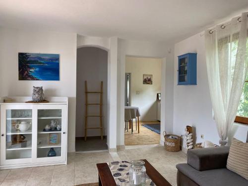 a living room with a couch and a table at Apartments Hortenzija in Maslinica