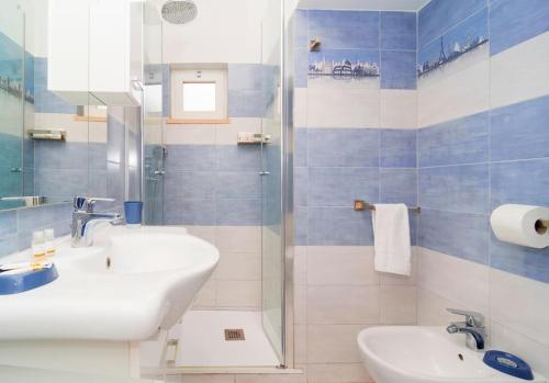 a bathroom with two sinks and a glass shower at Casetta Lucia in Massa Lubrense