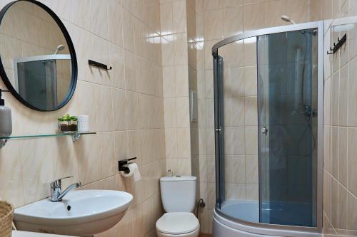 a bathroom with a toilet and a sink and a shower at Best Apartments on Kyryla & Mefodia in Mukacheve