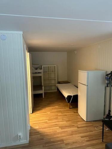 a small room with a refrigerator and a bedroom at Apartment in Lindvallen in Sälen