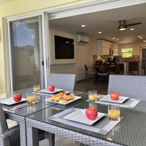 a dining table with apples and fruit on plates at 230A South Finger in Jolly Harbour