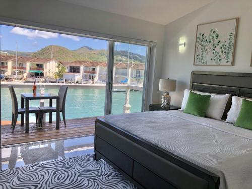 a bedroom with a bed and a view of a pool at 230A South Finger in Jolly Harbour