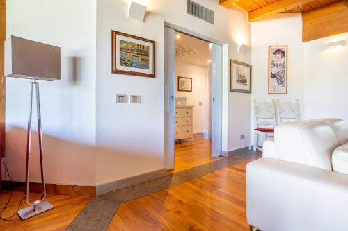 a living room with a white couch and a television at Casale Delle Ronde B&B in Latina
