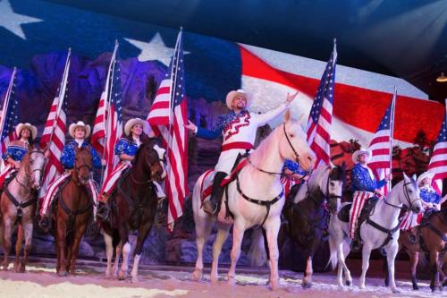 a group of people on horses holding american flags at 3BR Lake View Condo - Stairs Required - Close to Marina - Pool -FREE TICKETS INCLUDED - 700EP in Hollister