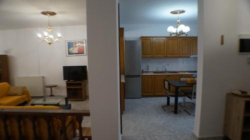 a kitchen and a living room with a dining room at VILLA KONSTADINE in Asprovalta