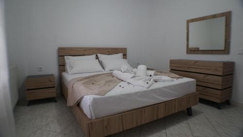 a bed with two stuffed animals sitting on top of it at VILLA KONSTADINE in Asprovalta