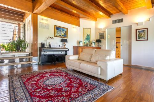 a living room with a couch and a piano at Casale Delle Ronde B&B in Latina