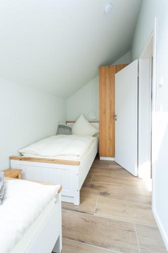 a bedroom with two beds and a closet at Geiseltalsee Haus am See mit Wallbox in Mücheln