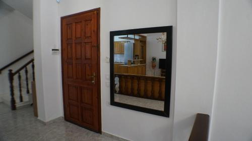 a mirror hanging on a wall next to a door at VILLA KONSTADINE in Asprovalta