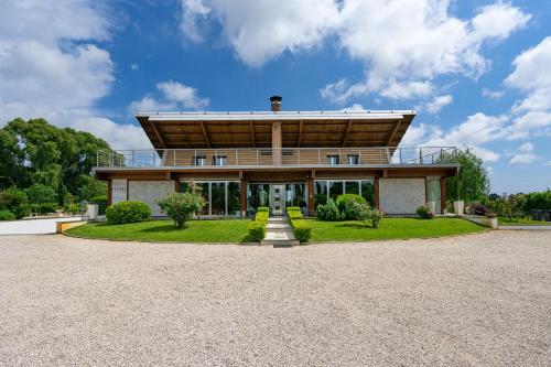 a large house with a roof on top of it at Casale Delle Ronde B&B in Latina