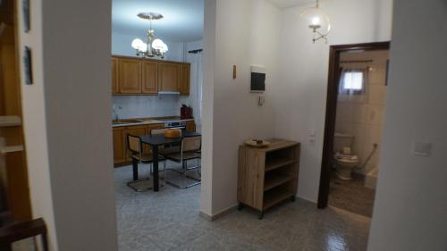 a kitchen with a table and a sink and a toilet at VILLA KONSTADINE in Asprovalta