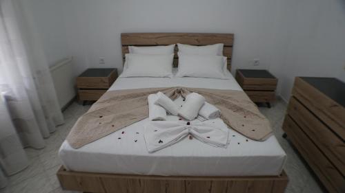 a bedroom with a bed with two bow ties on it at VILLA KONSTADINE in Asprovalta