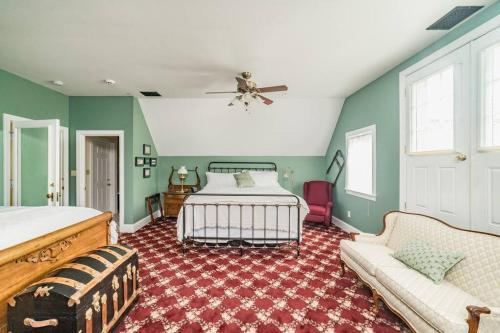 a bedroom with a bed and a couch at The Long Run - 2 CA King Sized Beds+ - Sleeps 8-10 in Lynchburg
