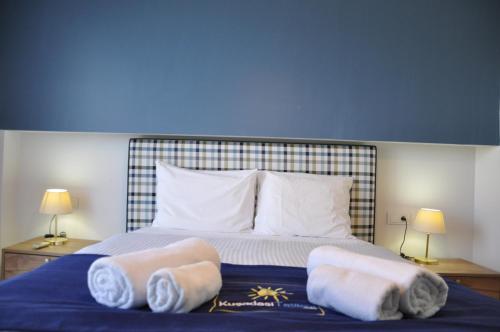 a bedroom with a bed with towels on it at Lavender Residence in Kusadası