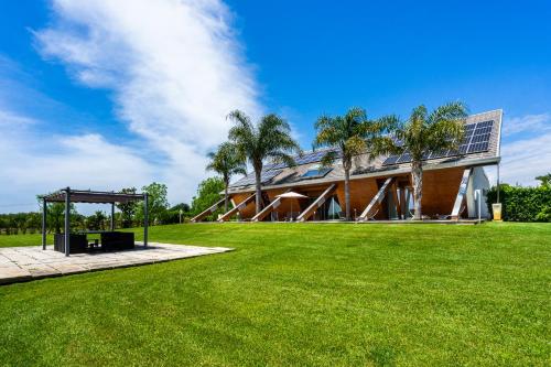 a building with a green lawn in front of it at Casale Delle Ronde B&B in Latina