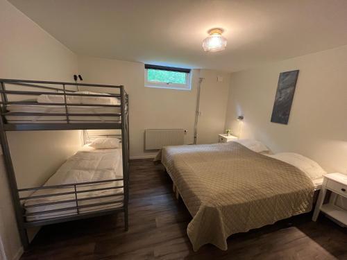 a bedroom with two bunk beds and a window at Furuvägen 11 D in Ullared