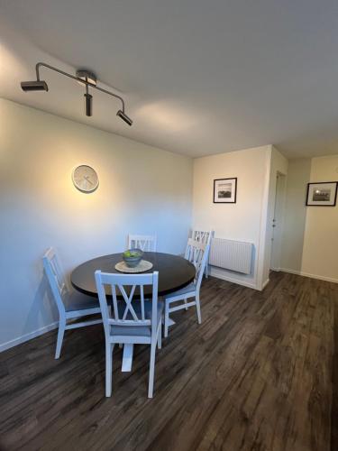a dining room with a table and chairs at Furuvägen 11 D in Ullared