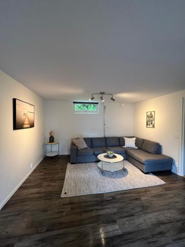 a living room with a couch and a table at Furuvägen 11 D in Ullared