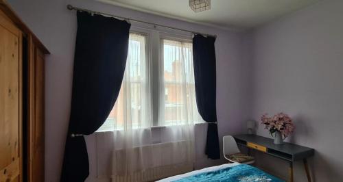 a bedroom with a window and a bed and a desk at 20 Gray Street in Dublin