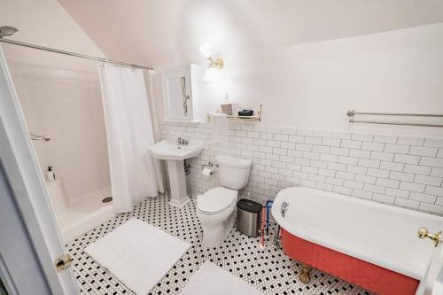 a bathroom with a tub and a toilet and a sink at Desperado - CA King Size Bed - Sleeps 2-4 in Lynchburg