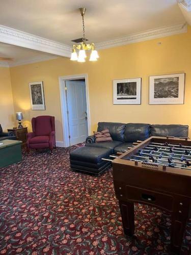 a living room with a couch and a pool table at Desperado - CA King Size Bed - Sleeps 2-4 in Lynchburg
