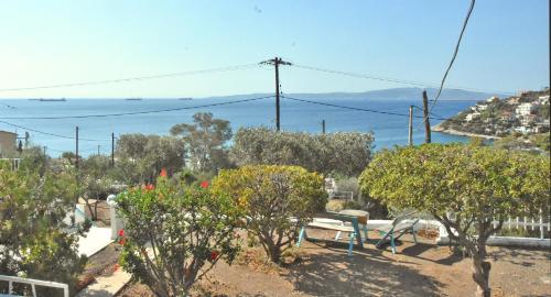 a bench in a garden with a view of the ocean at MNS Marvelous Nirvana Seascape, Philosophy in Perani