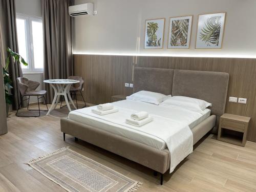 a bedroom with a bed with two towels on it at Deluxe Residence in Durrës