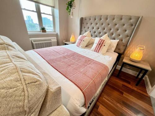 a bedroom with a bed with a blanket and a window at 502 Luxury 1BR apartment in center city in Philadelphia