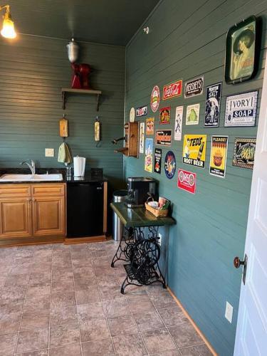 a kitchen with a blue wall with posters on it at Best of My Love - CA King Size Bed+ - Sleeps 2-4 in Lynchburg