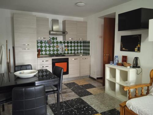 a kitchen with a table and a dining room at La casa sul farfa in Bocchignano