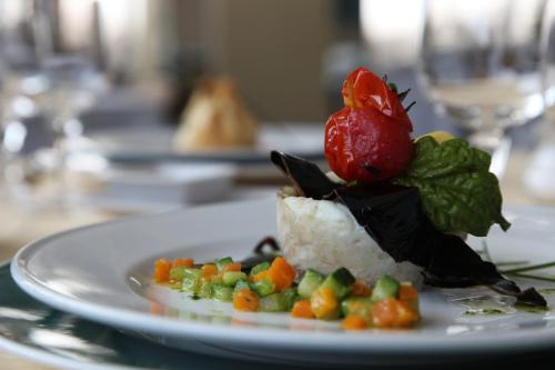 a plate of food with rice and vegetables on a table at Grand Hotel Terme in Margherita di Savoia