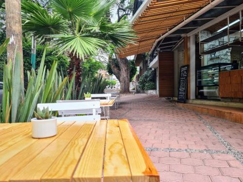 a table and benches outside of a building at Sisao Hotel-Café in Cuernavaca