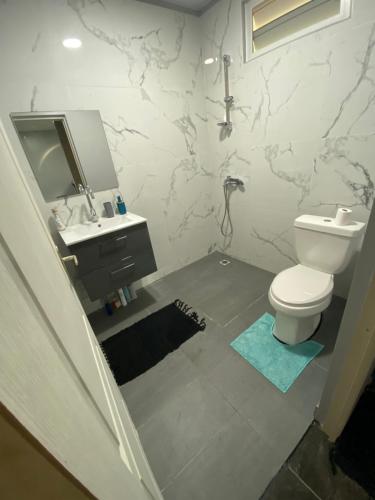 a bathroom with a toilet and a sink at Bora Temahana in Bora Bora