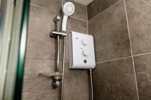 a shower in a bathroom with a thermostater at Cheviot Barn in Chatton