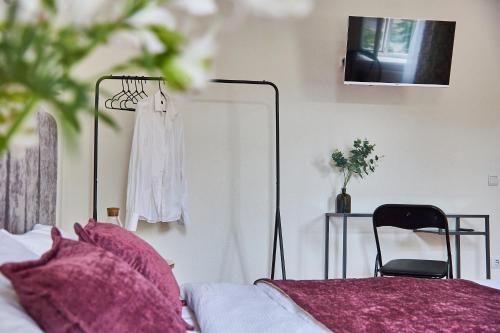 a bedroom with a bed and a table and a chair at Best Apartments on Kyryla & Mefodia in Mukacheve