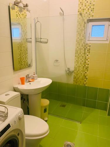 a bathroom with a toilet and a sink and a shower at Райское место in Šušanj