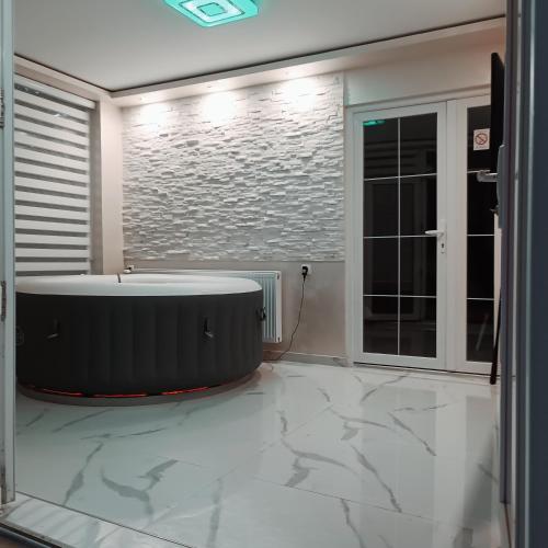 a bathroom with a large tub in the middle of a room at RB Apartment 1 (SPA) & 2 in Palić