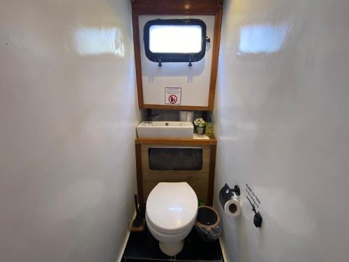 a small bathroom with a toilet and a window at göcek yat in Fethiye