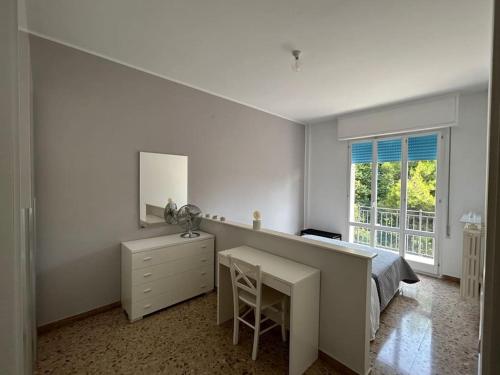 una camera da letto con scrivania, letto e finestra di - Chalet Urbano - a Fano