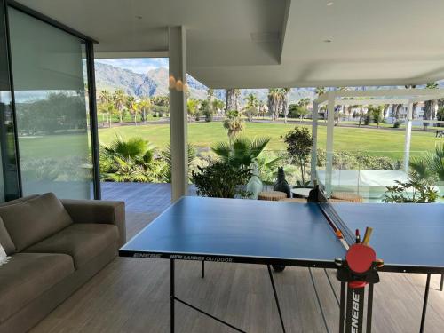 a ping pong table in the middle of a living room at Luxury Villa Rebeka - Heated Pool and Jacuzzi in Adeje
